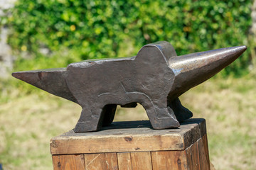 Iron anvil on wooden table