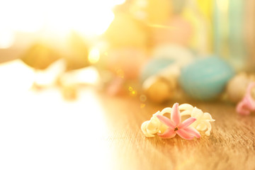 Flowers and blurred Easter eggs on background