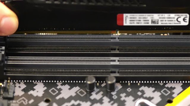 Installing memory kit on pc mainboard, close up view 