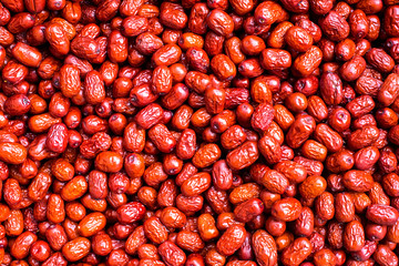 Dried jujube fruits as background.