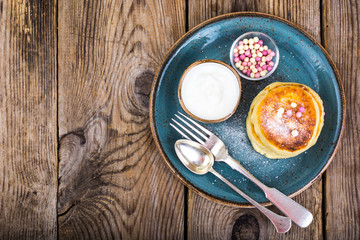 Hot delicious curd pancakes with fruit salad and yogurt