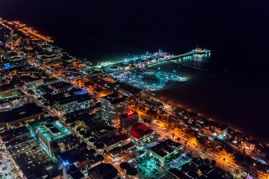 Aerial view of the Santa Monica shoreline, amusment park and pier at night © Tierney