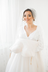 Portrait of beautiful bride with fashion veil at wedding morning.