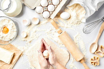 Baking preparation. Raw dough and cutters for the holiday cookies on a white table. Top view.