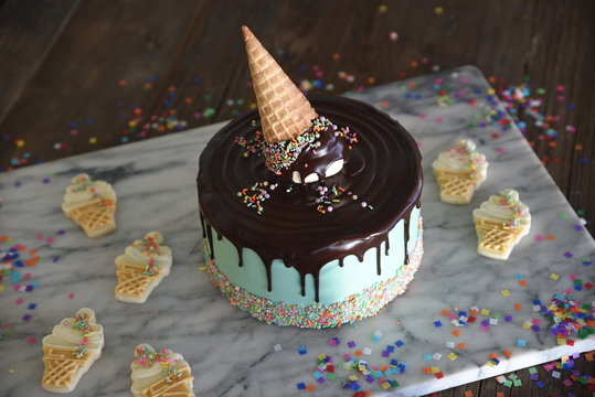 Celebration cake with melted ice cream decoration, and ice cream cookies