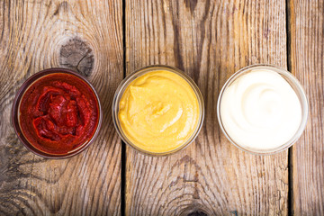 Obraz na płótnie Canvas Set of three classic sauces-mayonnaise, ketchup and mustard