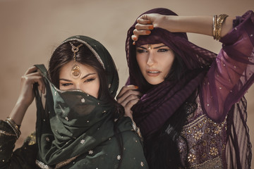 Arabian woman traveling in desert. - obrazy, fototapety, plakaty