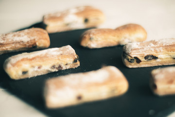 Strudel Apple and sugar powder. Biscuit from the puffed Test on the Gray Background. Dessert with Fruits.Copy space for Text. selective focus.
