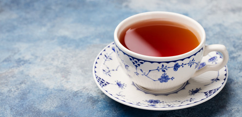 Cup of tea on a blue stone background. Copy space