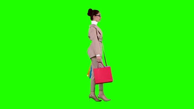 Girl goes shopping in the store. Green screen. Slow motion