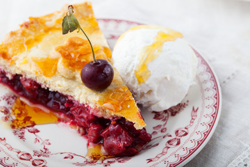 Slice of cherry pie with ice cream