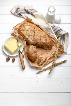 Fresh Bread With Crispy Crust Butter And Milk At White Wooden