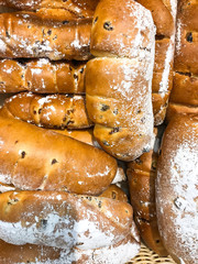 Sweet fresh buns with fruits and raisins in basket