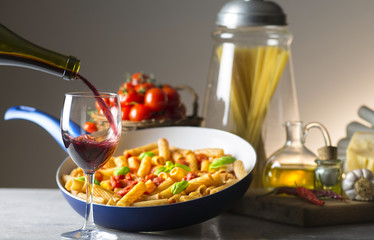 pot with macaroni and tomato sauce on the table