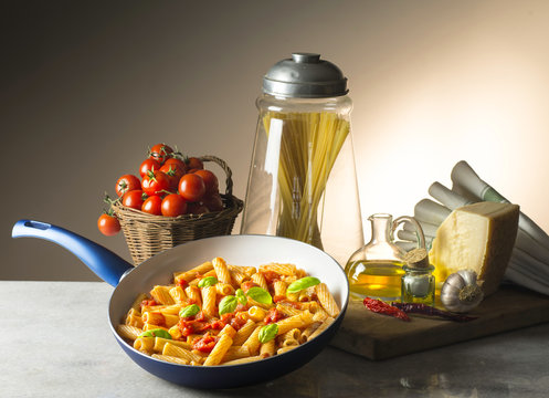 pot with macaroni and tomato sauce on the table