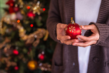 Girl hands holding Christmas ornament
