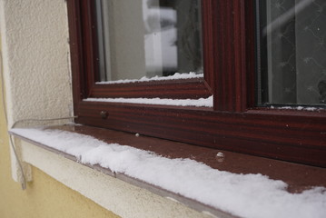 Snow On Home Window And House In Winter