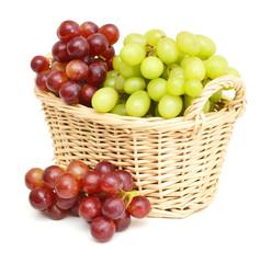 Ripe red and green grapes isolated in basket on white