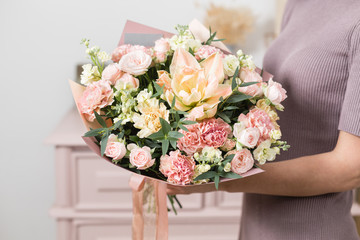 beautiful luxury bouquet of mixed flowers in woman hand. the work of the florist at a flower shop.