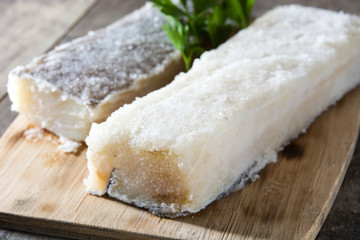 Salted dried cod on wooden table. Typical Easter food