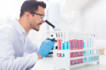 Pleasant male laboratorian conducting research