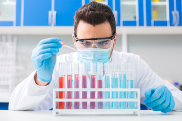 Focused male laboratorian succeeding in experiment