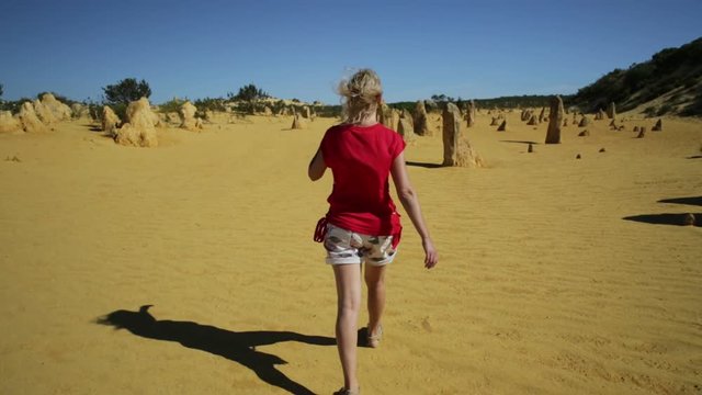 Western Australia travel freedom concept. Woman in the desert of Pinnacles. The yellow limestones in Nambung National Park of Cervantes, in WA state of Australia