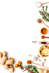 Seasoning background. Dry spices near ginger, garlic, rosemary on white background top view copy space
