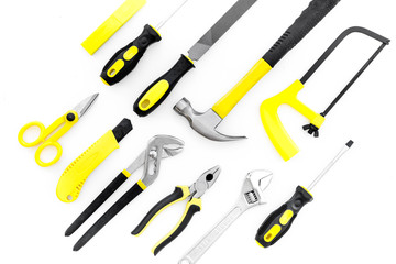 Tools for repair and building. File, saw, hummer on white background top view copy space