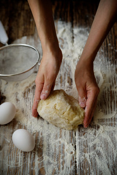 Female hands make dough for biscuit or pie
