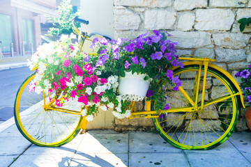 Fototapeta na wymiar charming street decoration - old bike with flowers