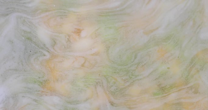 Foam atop water swirling above soup cooking.