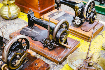 Black retro sewing machines in outdoor market
