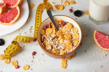 Healthy breakfast. Cereals, milk, fruit and measuring tape.