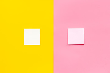 Fototapeta premium Note paper on pink and yellow background top view copy space
