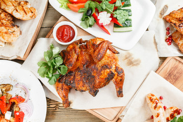 grilled chicken. Serving on a wooden Board on a rustic table. Barbecue restaurant menu, a series of photos of different meats