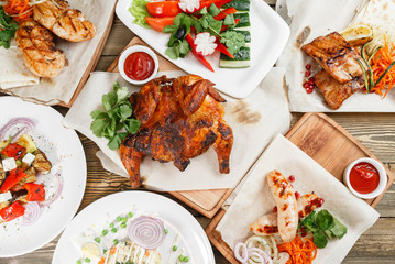 grilled lots of food . Serving on a wooden Board on a rustic table. Barbecue restaurant menu, a series of photos of different meats