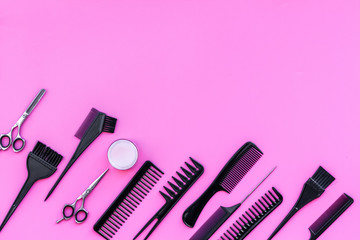 Beauty saloon equipment. Hairdress, haircut. Combs, sciccors, brushes on pink background top view...