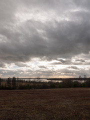 Fototapeta premium moody skyline clouds over autumn farm field