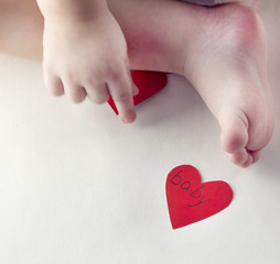 Handle and a baby's leg and a red heart