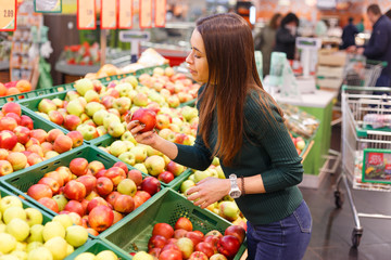 Young woman buy apples in farm food store
