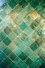 Green Moroccan Arabic tiles pattern on a wall