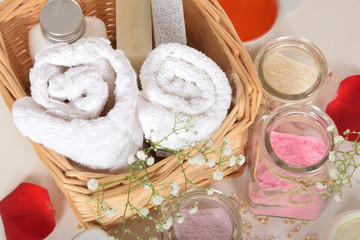 white clean towel with bath cosmetics with a natural gray soap with pumice stone and body lotion...