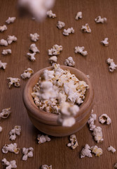 Homemade popcorn in a wooden bowl on the table