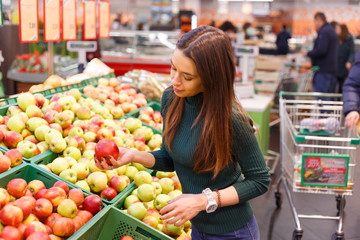 Young woman buy apples in farm food store