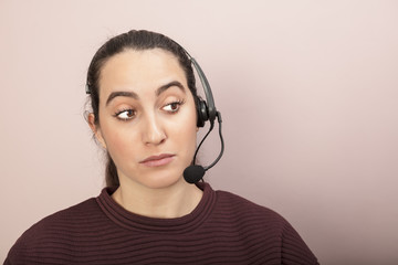 Sceptical help desk operator listening to a call..