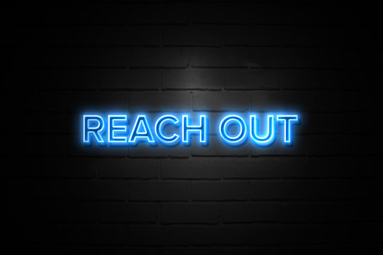 Reach Out neon Sign on brickwall