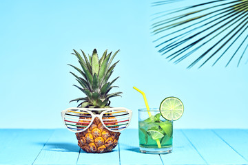 Tropical Pineapple Hipster with Cocktail on Beach. Bright Summer Color. Trendy fashion Style. Hot summer Vibes. Creative Art. Fun party Mood. Minimal