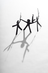 Black Paper figures with automatic guns. Terror.