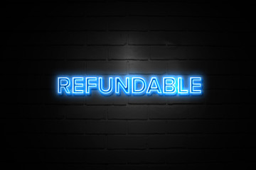 Refundable neon Sign on brickwall